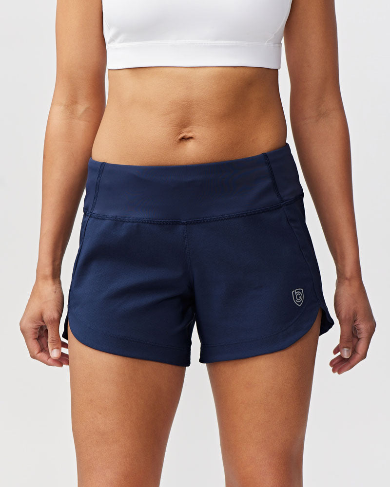 Person wearing navy athletic shorts on a white background